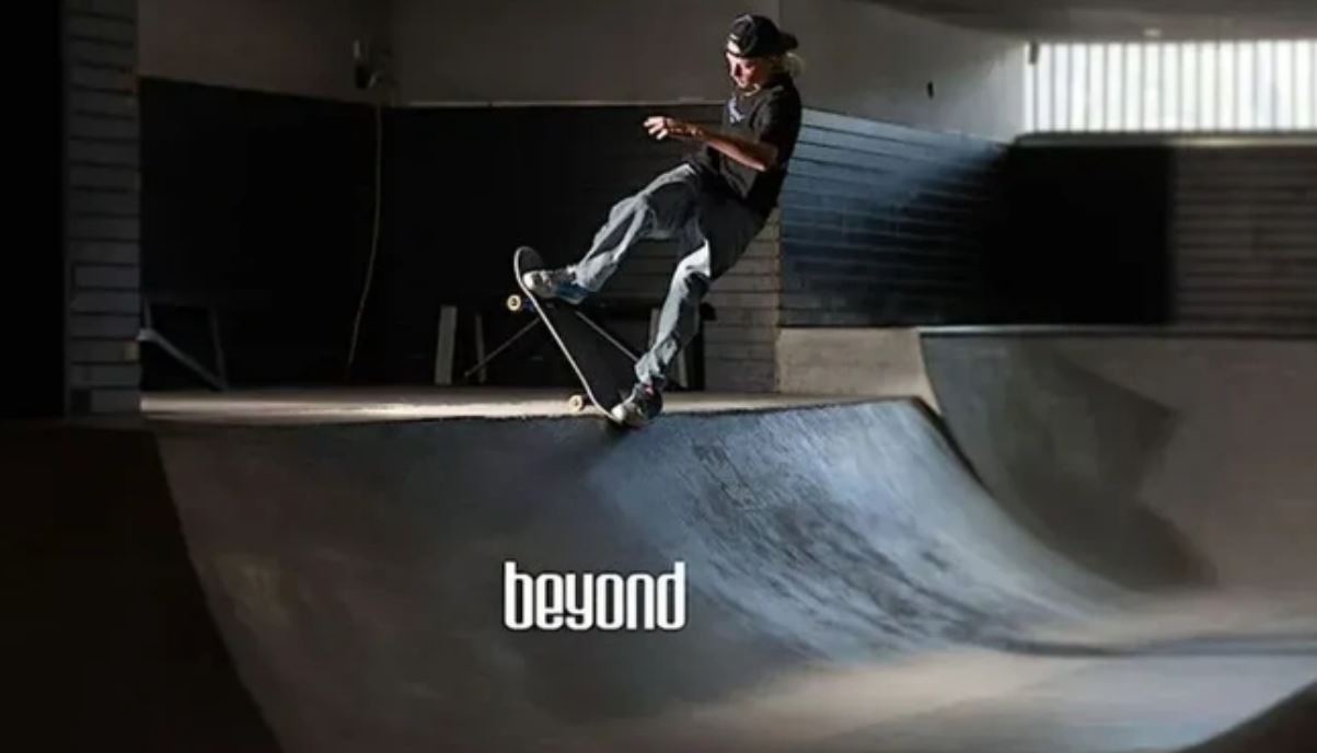 a teen skateboarding up a ramp with the text BEYOND in the foreground
