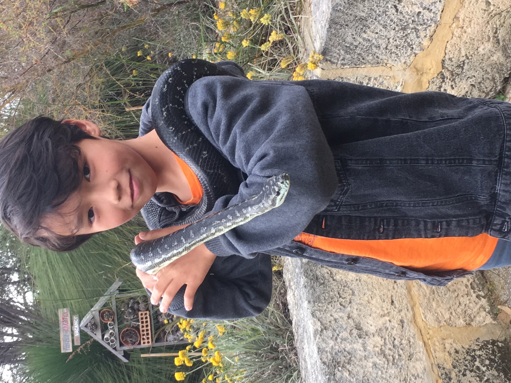 Boy holding snake 