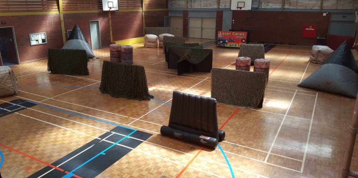 An indoor sports court with obstacles to hide behind