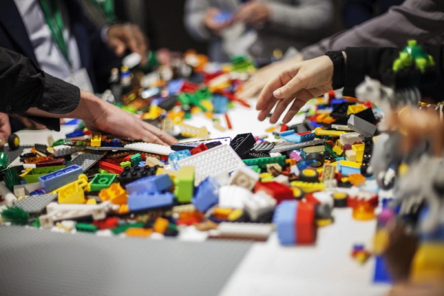 pile of lego with kids hands reaching in