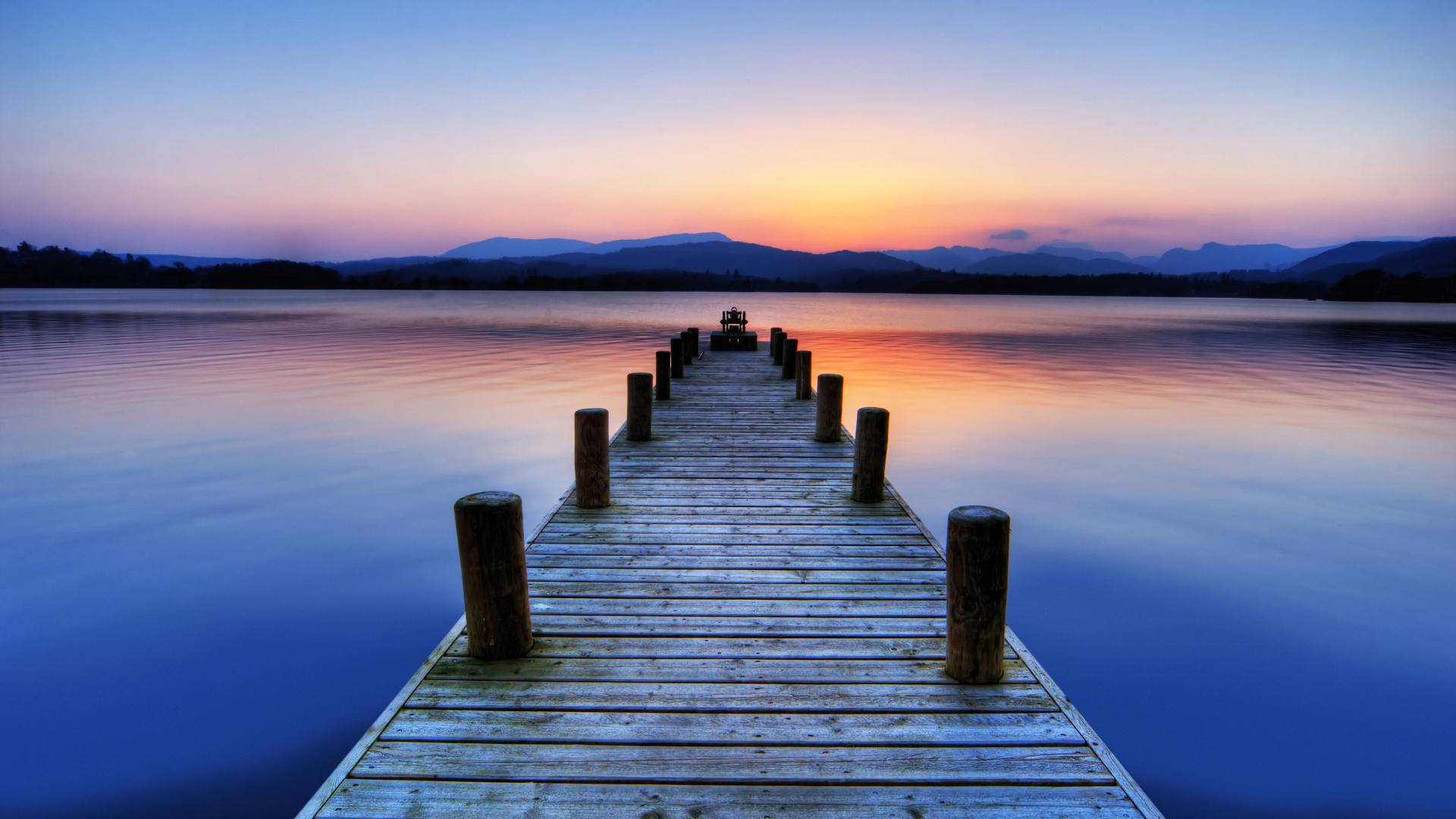 image of jetty and water at sunset
