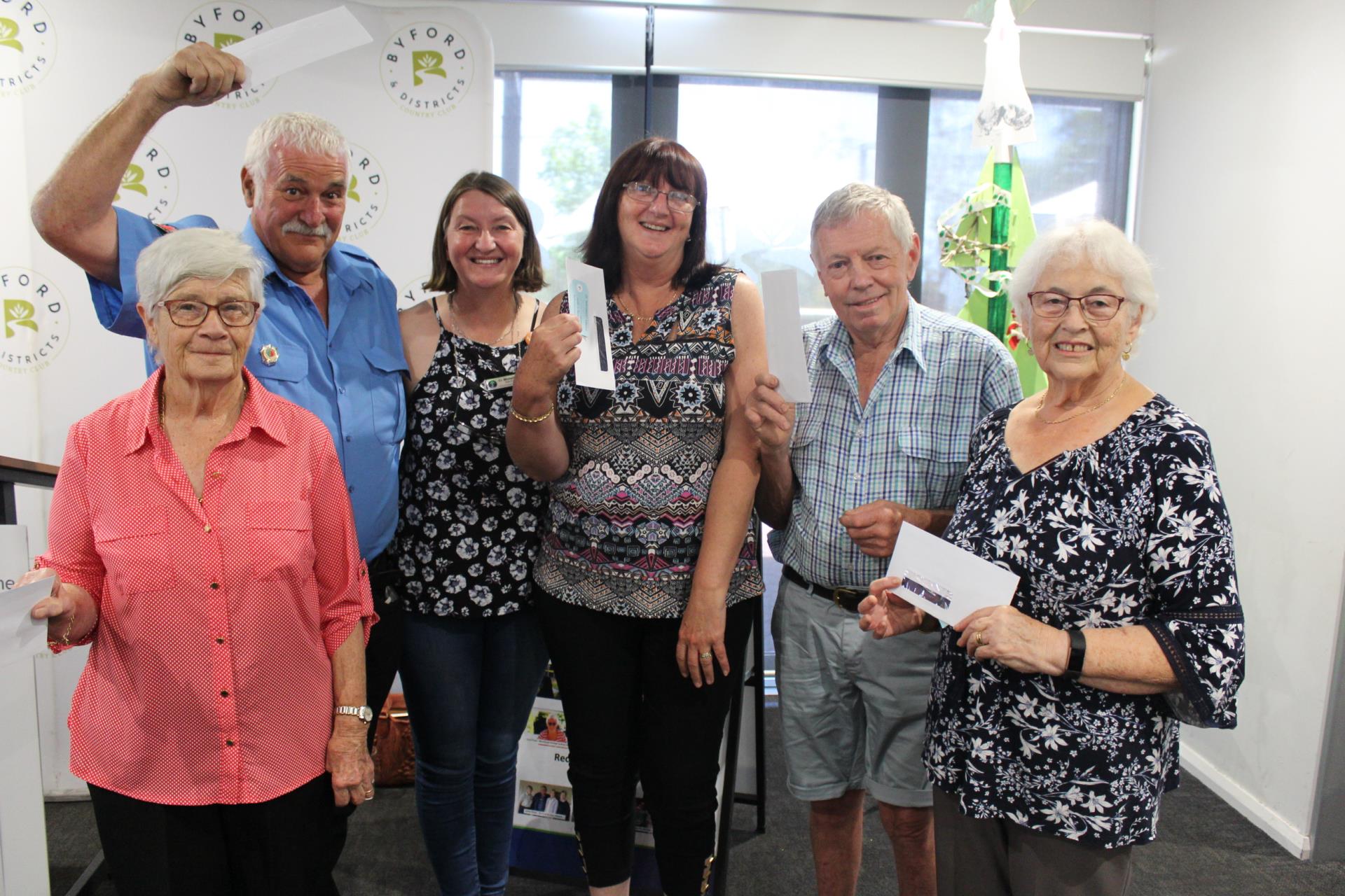 Shire President Cr Michelle Rich presents a $50 gift voucher from Byford & Districts Country Club to lucky volunteers Helen Rowe, Byford United Church, Neil Munkley, Byford Volunteer Bushfire Brigade, Christine Wales, Byford Glades Community Garden Inc., Charles Kerfoot, Jarrahdale Heritage Society and Yvonne Lovegrove, Byford Progress Association.